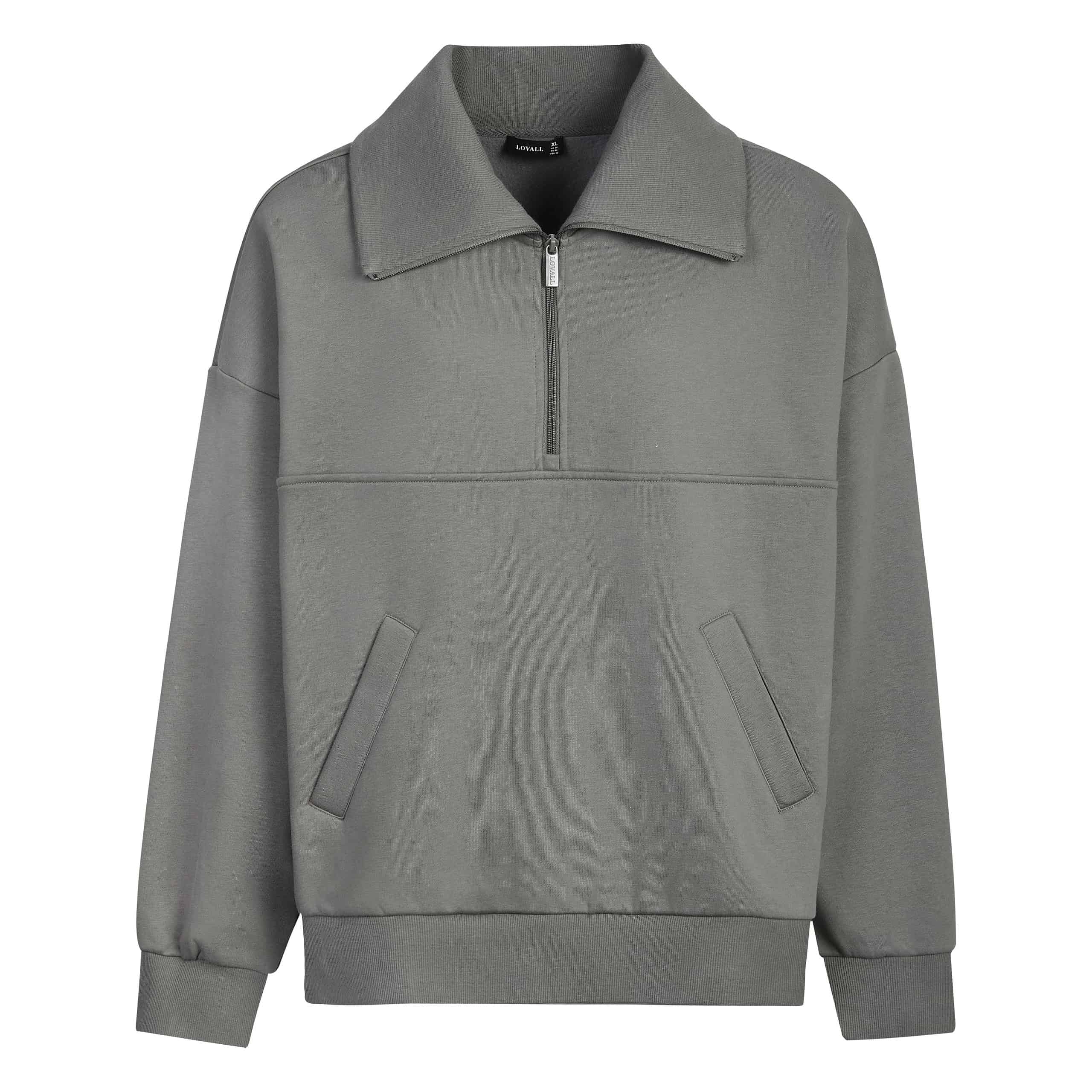 Discover the Lovall Loungewear gray quarter-zip sweatshirt, featuring a large collar, front pockets, and cuffed sleeves. This size-inclusive loungewear piece ensures ultimate comfort and style, elegantly showcased against a white background.